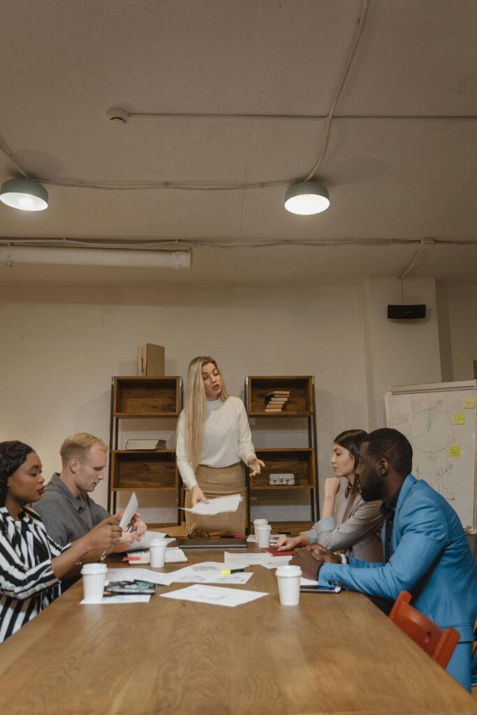 A group of diverse professionals in a brainstorming meeting in a modern office.